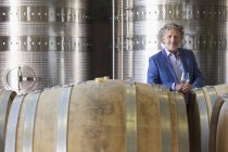 Portrait confident vintner in winery cellar — Stock Photo