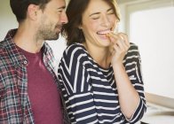 Laughing couple hugging indooors — Stock Photo