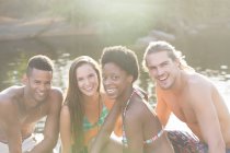 Friends smiling at riverside during daytime — Stock Photo