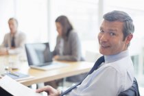 Businessman smiling in office indoors — Stock Photo