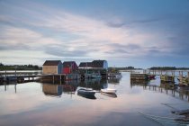 Rowboats and buildings on calm bay — Stock Photo