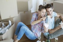 Couple sharing Chinese take out food in new house — Stock Photo