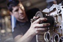 Close up mechanic fixing part in auto repair shop — Stock Photo
