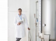 Scientist smiling in food processing plant — Stock Photo