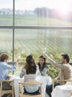 Friends toasting wine glasses in winery dining room — Stock Photo