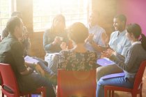 Group therapy session clapping in circle — Stock Photo