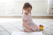 Girl in dress drawing with crayons — Stock Photo