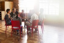 Group therapy session in circle in sunny community center — Stock Photo