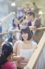 Female college students talking in stairway — Stock Photo