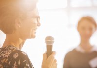 Close up woman speaking with microphone — Stock Photo