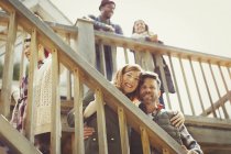 Portrait smiling couple on stairs outside cabin — Stock Photo