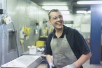 Smiling worker in steel factory — Stock Photo