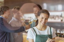 Portrait smiling worker with clipboard in winery tasting room — Stock Photo