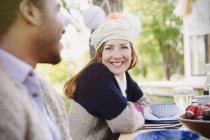 Portrait smiling woman at patio lunch table — Stock Photo