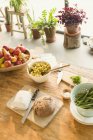 Pasta, fruit, bread, butter and asparagus on dining table — Stock Photo