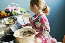 Girl with digital tablet baking in kitchen — Stock Photo