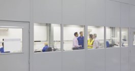 Managers and workers in steel factory office — Stock Photo