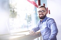 Портрет усміхненого бізнесмена з бородою в ноутбуці в кафе — стокове фото