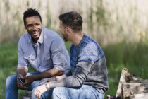 Smiling men talking outdoors — Stock Photo