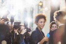 Celebrity being interviewed and photographed by paparazzi at event — Stock Photo