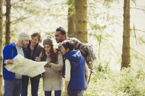 Friends with map hiking in woods — Stock Photo
