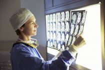 Surgeon reviewing MRI scans at medical clinic — Stock Photo