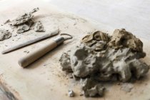 Clay and equipment on board in pottery studio — Stock Photo