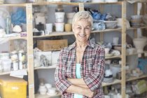 Portrait senior artist in pottery studio — Stock Photo