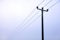 Power lines under overcast sky — Stock Photo