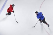 Overhead view hockey opponents with puck — Stock Photo
