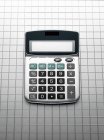 Calculator on grid gray background — Stock Photo