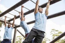 Men on monkey bars at boot camp — Stock Photo