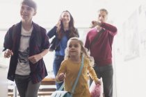 Family rushing to leave house — Stock Photo