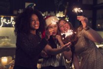 Playful young women with sparklers — Stock Photo