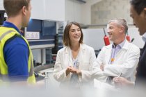 Smiling engineers and managers in steel factory — Stock Photo