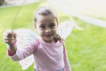 Portrait smiling girl in fairy wings — Stock Photo