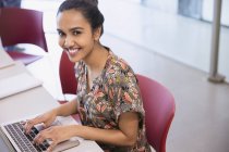 Portrait smiling college student using laptop — Stock Photo