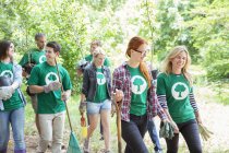 Smiling environmentalist volunteers planting new tree — Stock Photo