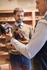 Businessman shopping for dress shoes in menswear shop — Stock Photo