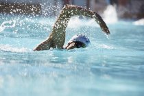 Male swimmer athlete swimming in swimming pool — Stock Photo