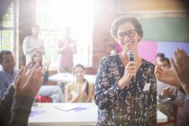 Audience clapping for woman in community center — Stock Photo