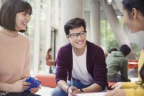 Smiling college students talking in commons — Stock Photo