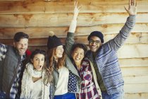 Portrait playful friends cheering outside cabin — Stock Photo