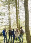 Friends talking and hiking in sunny woods — Stock Photo