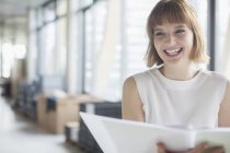 Businesswoman laughing in office — Stock Photo