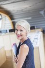 Businesswoman holding paperwork in office — Stock Photo