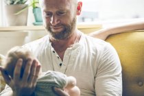 Portrait of father holding baby — Stock Photo