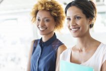 Portrait of two smiling businesswomen in office — Stock Photo