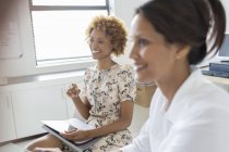Two smiling businesswomen during meeting in office — Stock Photo