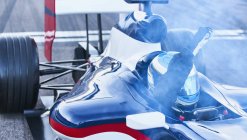 Formel-1-Rennfahrer jubelt mit der Faust über Ziellinie auf Sportstrecke — Stockfoto